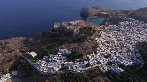 circling aerial shot of lindos town and acropolis rhodes