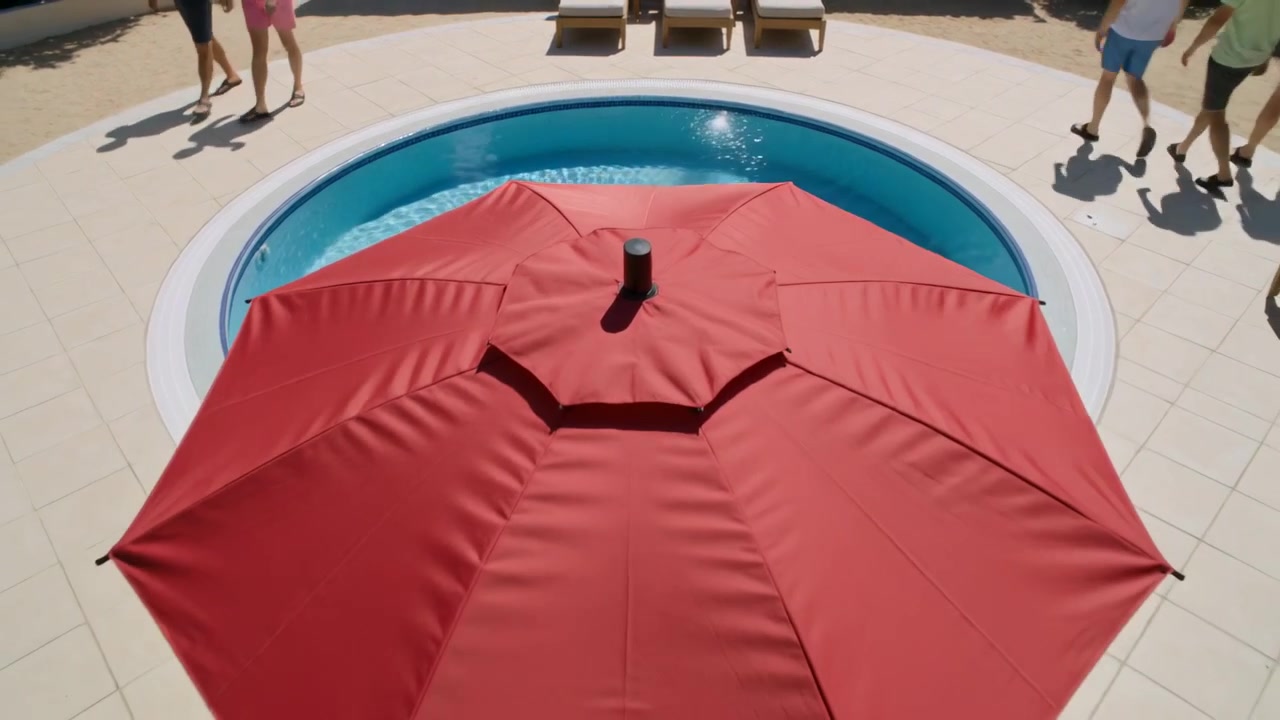 Ombrellone rosso da patio che si apre sopra una piccola piscina circolare nel patio di un resort, con ospiti che passano.