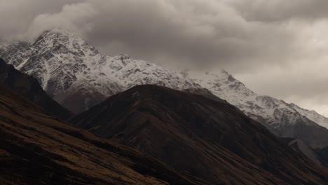 new zealand autumn season landscape with mountains during rain, with cloud moving fast in the mountains