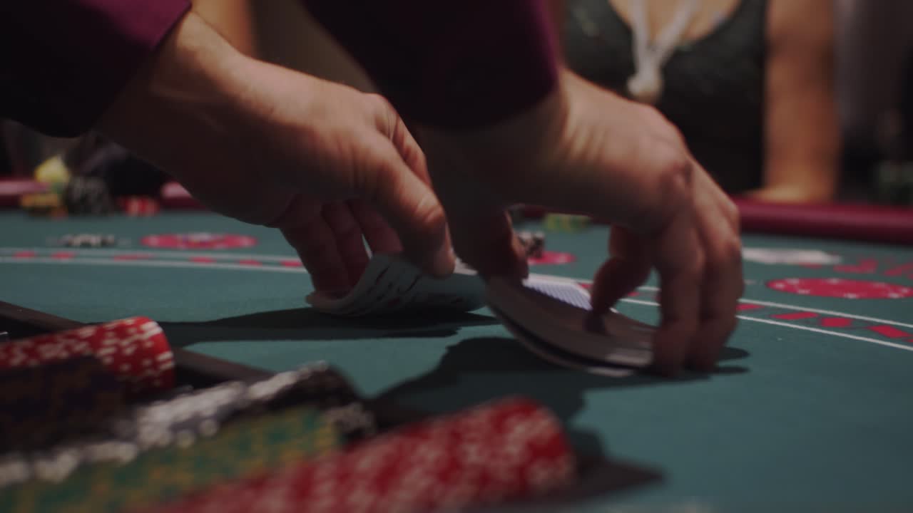Dealer shuffling cards for Blackjack at casino table