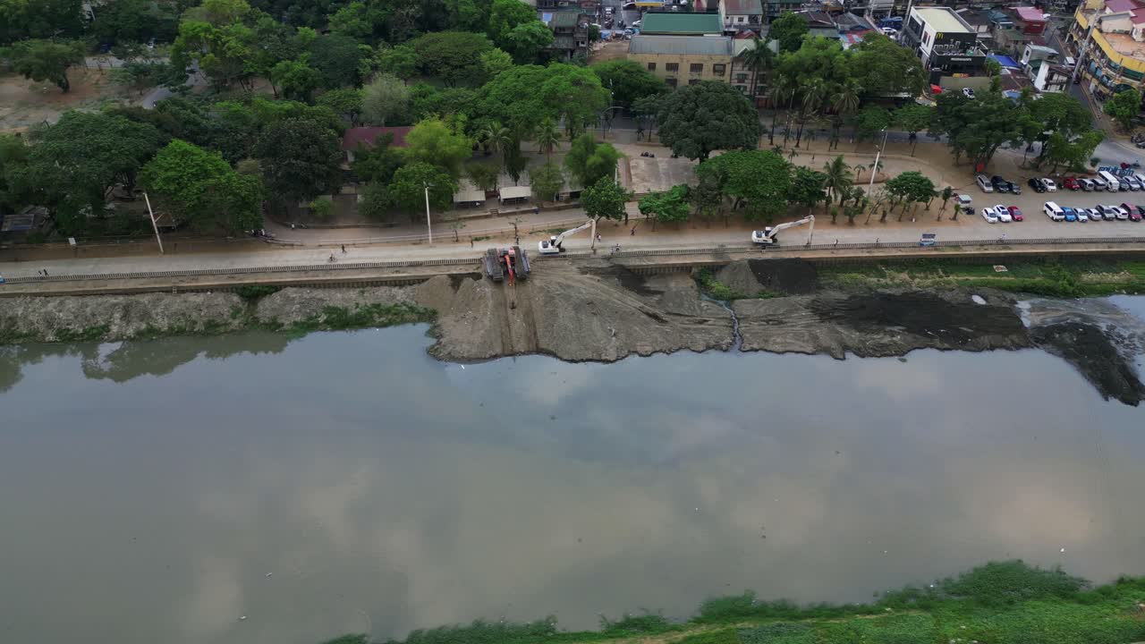 Heavy Construction Machines Along Riverbanks Of Marikina City, Metro Manila, Philippines. Aerial Drone Shot