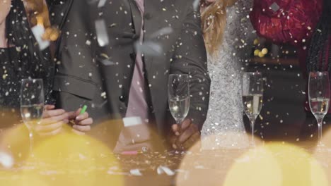 Close-Up-of-Confetti-Falling-on-Friends-Celebrating-New-Years-Eve