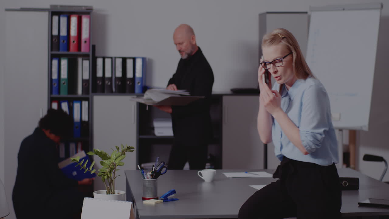 Office scene with people working and talking on the phone