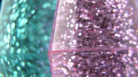 swirling pink glitter with blue bokeh background