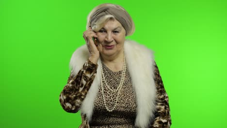 Elderly-stylish-caucasian-grandmother-woman-talking-on-mobile-phone.-Chroma-key