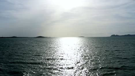 The-open-ocean-with-islands-in-the-background-during-a-tropical-sunset