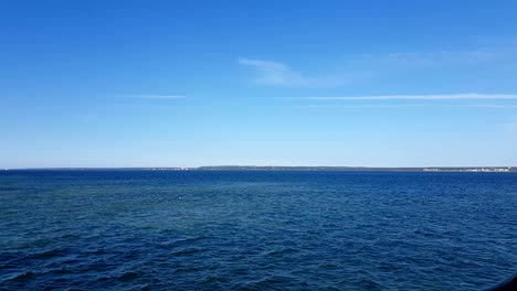 view of the ocean and clouds in the sky. blue sky with clouds in sunny weather over the ocean.