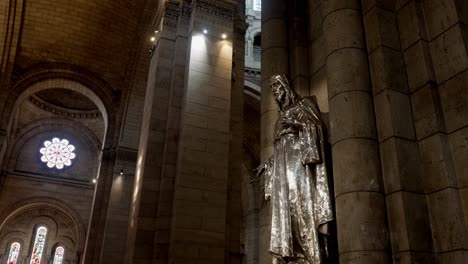 wide angle view of jesus christ statue displayed in the basilica of the sacred heart of paris.