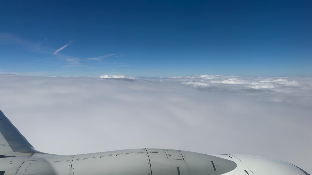Flight above the clouds covering the earth. View from the airplane window.