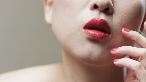 asian woman with black hair, red lips and red nails, copy space, slow motion