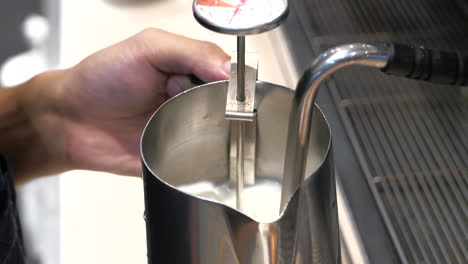 barista steaming milk for coffee drink