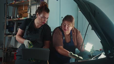 women mechanics working on a car