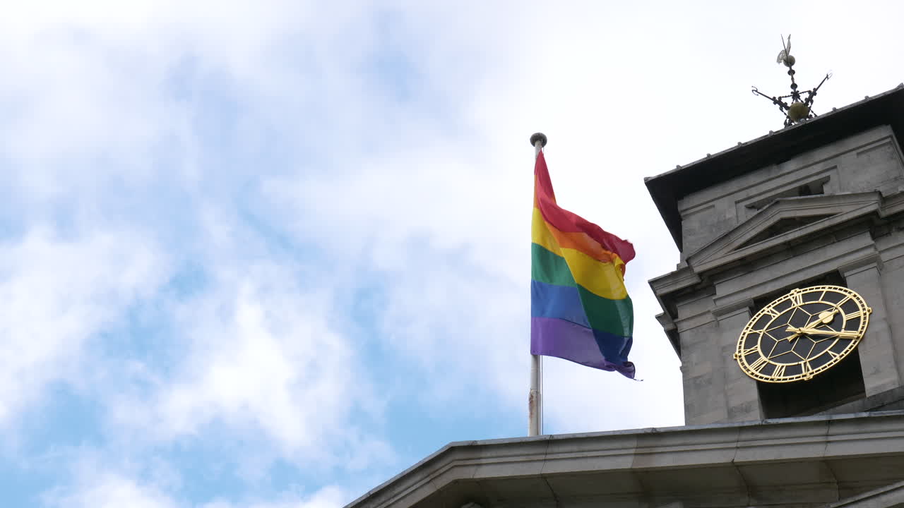 Close Up Rainbow Gay Pride Flag Flying Above Town Hall