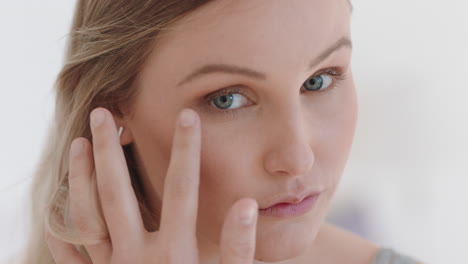 beautiful-young-woman-looking-in-mirror-at-perfect-healthy-skin-touching-face-with-hands-enjoying-smooth-natural-complexion-with-anti-aging-skincare-getting-ready-at-home-beauty-concept