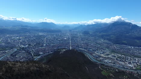 flying over a mountainside overlooking grenoble city