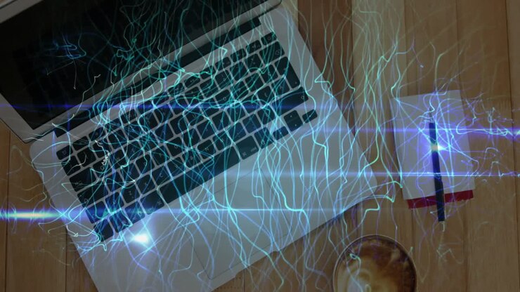 Laptop glowing with swirling blue digital overlays on wooden desk including notebook pen coffee