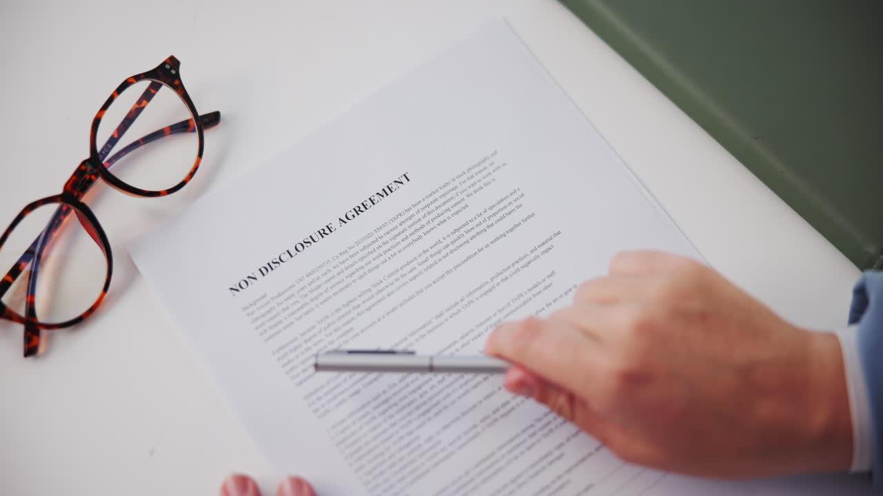 Non Disclosure Agreement with Pen and Glasses