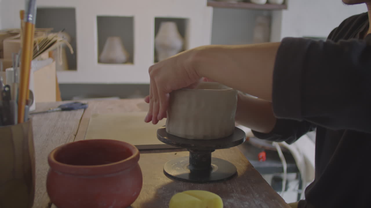 Young Asian Potter Working on Ceramic Vase