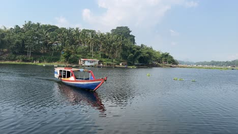 traditional wooden boat sailing on lake