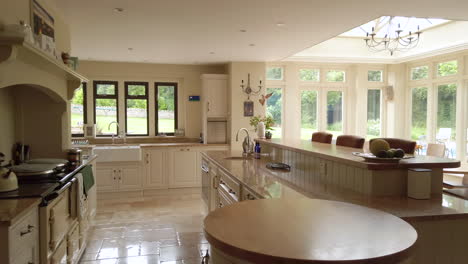 left to right pan of a large contemporary kitchen in a family home in slow motion