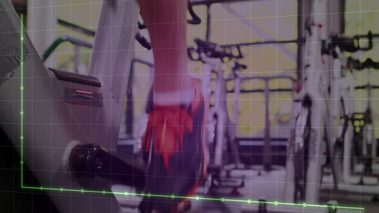 Male rider pedaling, gripping bars, camera panning from pedal to face cadence driving fitness graph