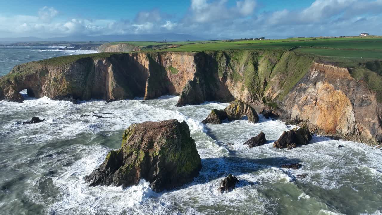 Ireland winter storm drone pullback coast and cliffs battered by high seas causing coastal erosion Copper Coast Waterford