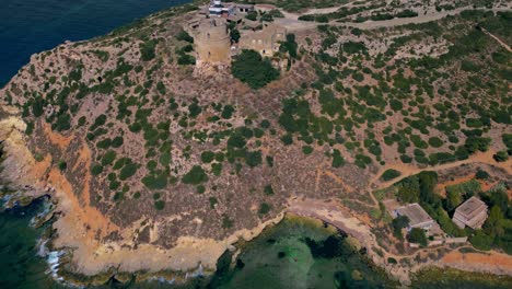 Aerial-reveal-of-Calamosca-Tower-and-the-beautiful-land-and-sea-beyond