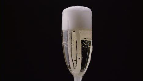 champagne glasses with champagne rotating on a black background champagne glasses with champagne rotating on a black background concept celebrating time new years eve valentines day