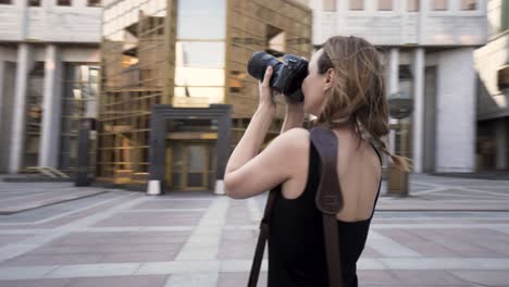 woman taking photos in the city