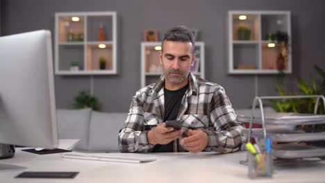 Man-working-on-computer-at-home.