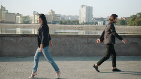 business couple high fiving outside