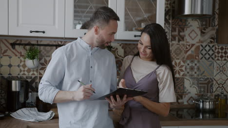 Couple reviewing document in the kitchen
