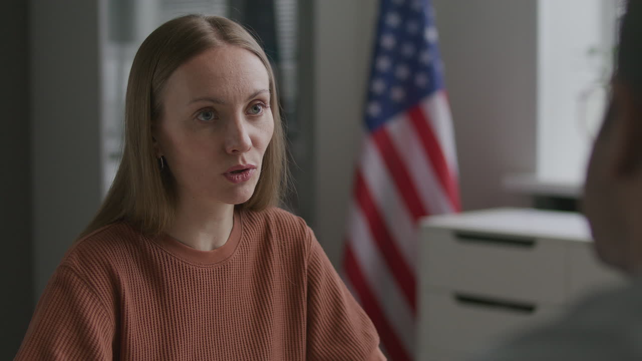 Female Visa Applicant Responding to Consular Officer during Formal Interview