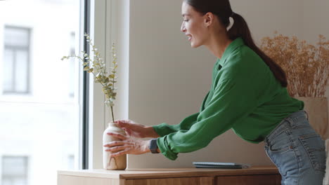 woman arranging flowers at home