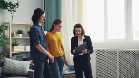 couple viewing a house with a real estate agent