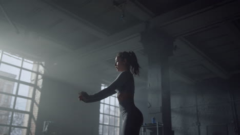 sportswoman stretching back before training. girl warming muscles for exercises