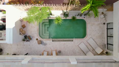 aerial top down of a white tropical pool villa design in bali