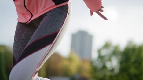 Tilt-up-view-of-jogging-woman-tying-her-sports-shoes