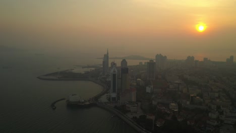 sunset time qingdao city famous beach bay modern sea palace aerial panorama 4k china