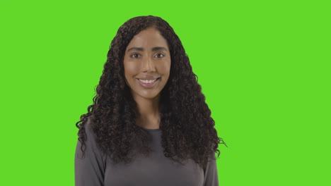 Portrait-Of-Woman-Against-Green-Screen-Smiling-At-Camera