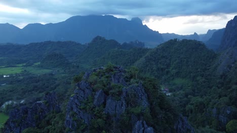 spinn around limestone summit revealing laos landscape, vang vieng