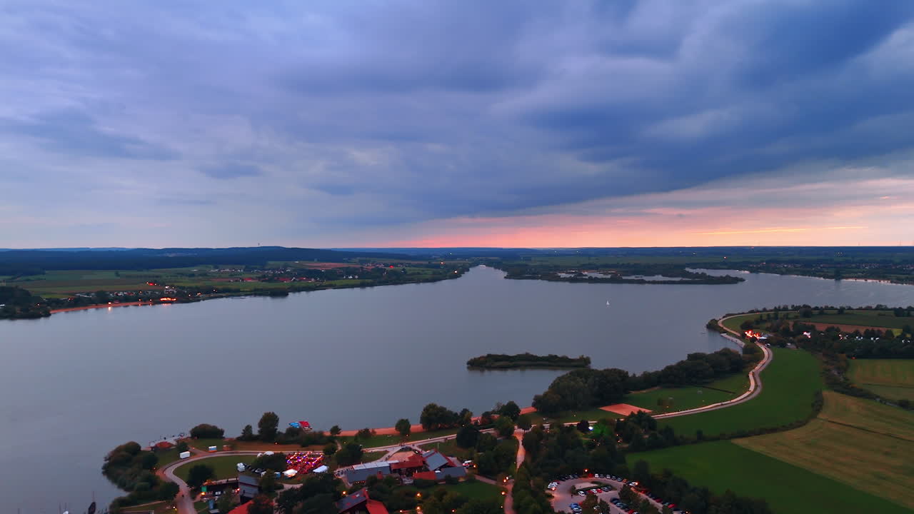 Patchwork fields under soft clouds. Colorful patchwork fields stretch to horizon under soft sky