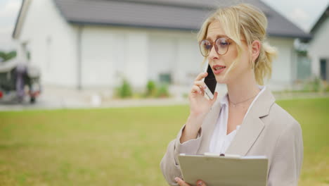 real estate agent discusses sales transaction on phone