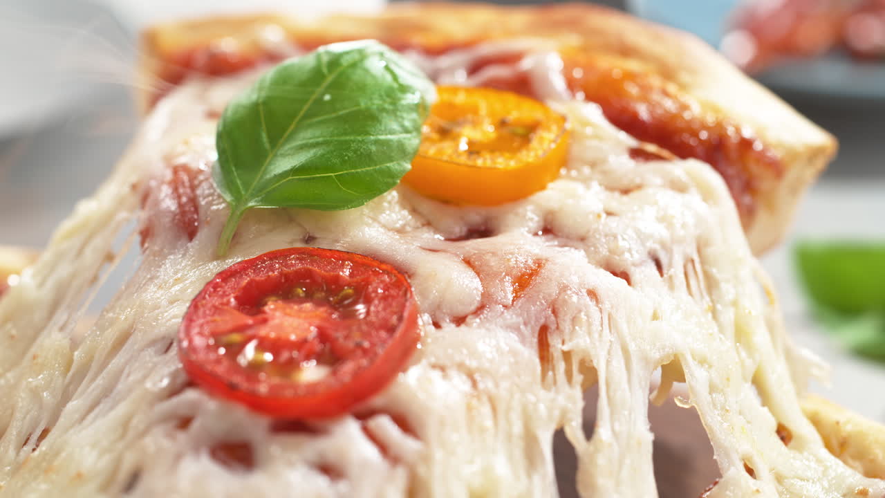 녹은 모차라 치즈, 토마토, 바질과 마르게리타 피자 조각 위에 스파라로 어 놓은 맥로 및 느린 동작