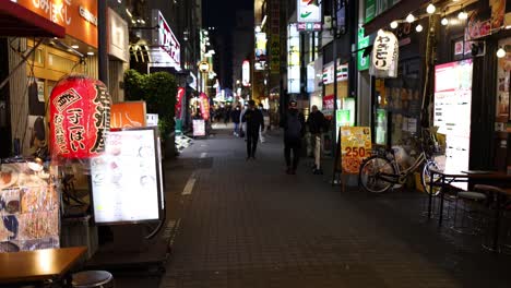 pedestrians walking through a lively urban alley