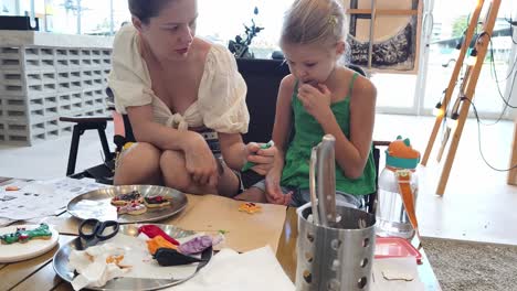 mother and daughter decorating christmas cookies