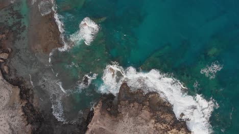 Clear-turquoise-water-from-a-top-down-moving-towards-the-shore