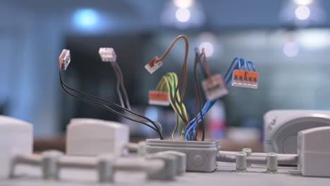 electric wires in different colors sticking out of a junction box