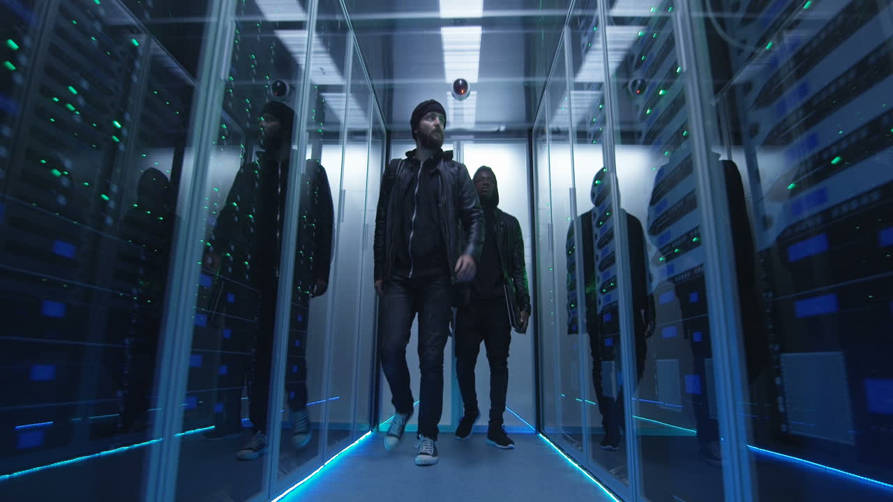 Men walking in a modern server room