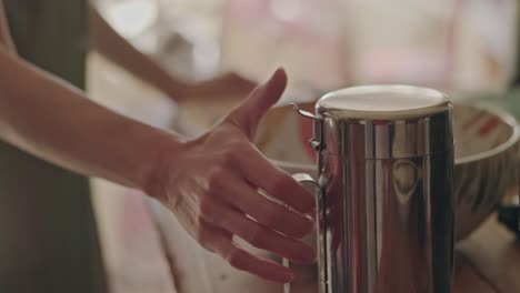 a chef pours olive oil from a metal jug into a vibrant salad bowl, setting the stage for a healthy and rustic dinner